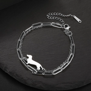 Close-up of dual-layer stainless steel bracelet featuring a polished dachshund charm