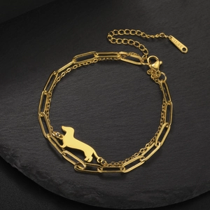 Detail of golden dachshund pendant on double-layer stainless steel cuban chain