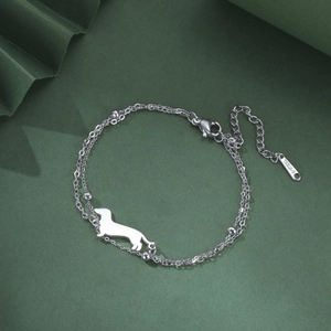 Detail of silver stainless steel double chain bracelet with dachshund dog charm pendant