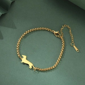 Detail of golden dachshund charm on stainless steel box chain with engraved tag