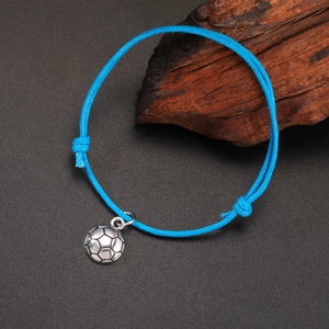 Detailed view of sky blue braided cord bracelet featuring a silver football charm