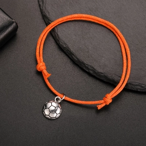 Detail of adjustable orange braided soccer charm bracelet with silver metal pendant