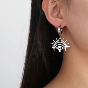 Silver Horus Eye stainless steel drop earrings shown on a model in a close-up ear view