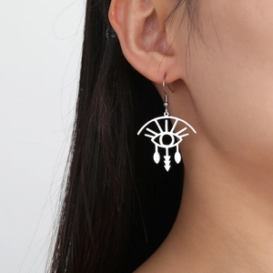 Minimalist silver stainless steel eyelash eye drop earrings worn by a model