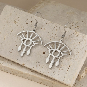 Minimalist silver stainless steel eyelash eye pendant earrings on travertine stone