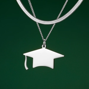 Detailed view of polished stainless steel graduation cap pendant with tiered chain layering