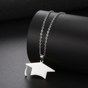 Detailed view of polished silver graduation cap pendant with a fine metal chain link