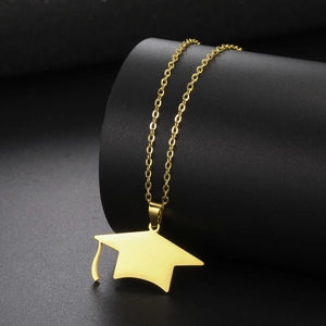 Macro shot of gold-plated graduation cap pendant with high-quality polished metal finish