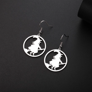 Detailed close-up of witch on broom silhouette earrings made of polished stainless steel