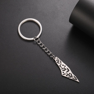 Detailed macro view of Israel map keychain with hollow floral pattern on black surface