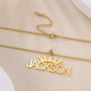 Detail of custom golden crown name necklace with Jackson pendant and adjustable chain link