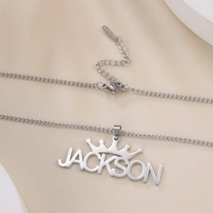 Detailed close-up of custom crown name necklace with Jackson pendant in silver finish