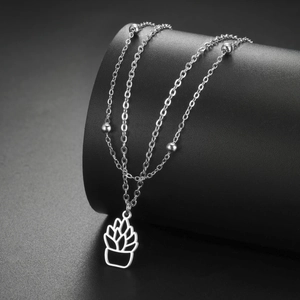 Detail of silver double-layer necklace with cactus pendant and polished metal beads