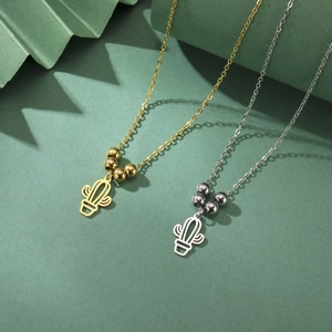 Detail of minimalist gold and silver cactus pendant necklaces with delicate bead accents