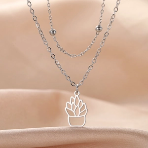 Detail of silver stainless steel double-layered necklace with hollow succulent plant pendant