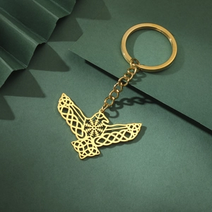 Golden Celtic eagle wing keychain made of stainless steel with Norse protective symbols