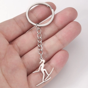 Porte-clés skieur en acier inoxydable argenté avec pendentif silhouette d'athlète épuré