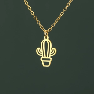 Macro shot of minimalist gold cactus pendant necklace with hollowed-out metal details