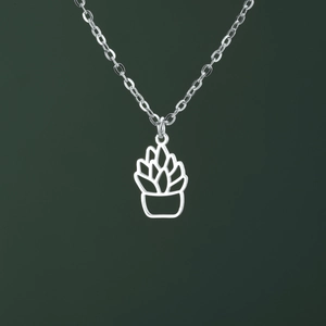 Detail of silver succulent plant pendant with cutout design on a dark green background