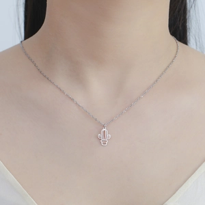 Close-up of minimalist cutout cactus pendant necklace on neck for a modern look
