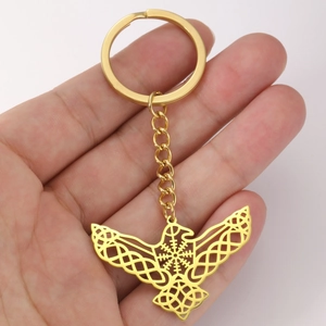 Detailed close-up of golden eagle wings keychain featuring intricate Celtic knot patterns