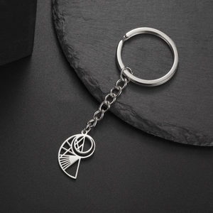 Detailed view of silver stainless steel keychain with unique geometric conch shell pendant