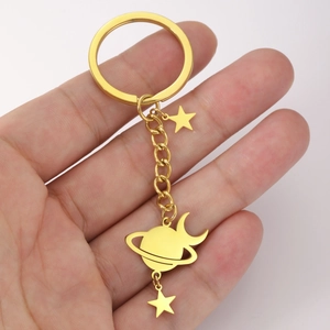 Polished gold stainless steel celestial keychain with saturn, stars and moon charms