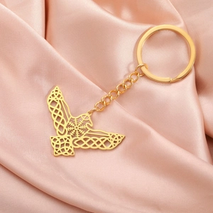 Detail of golden stainless steel eagle wing keychain with Vegvisir and Celtic knot pattern