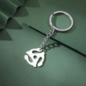 Close-up of a silver stainless steel keychain with a geometric spiral pendant