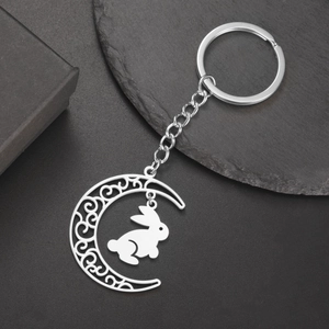 Vue détaillée du pendentif lune en acier inoxydable avec motif évidé et charme lapin