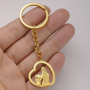 Porte-clés cœur doré avec silhouette mère et fille tenu en main pour un cadeau