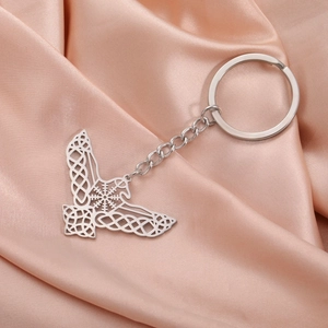 Macro detail of Celtic knot eagle wing pendant in silver-tone stainless steel