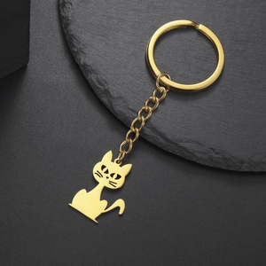 Detailed view of a golden stainless steel kitten charm keychain with hollowed-out craftsmanship
