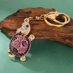Sparkling rhinestone turtle keychain with pink and purple crystals on gold alloy base
