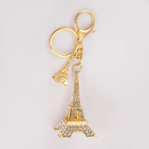Close-up of golden Eiffel Tower keychain with sparkling rhinestones and lobster clasp