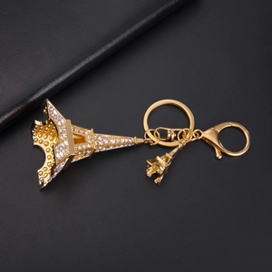 Macro view of golden Eiffel Tower keychain with sparkling rhinestones and lobster clasp