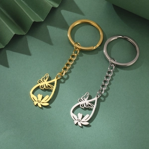 Pair of hollowed-out butterfly and flower keychains in gold and silver stainless steel