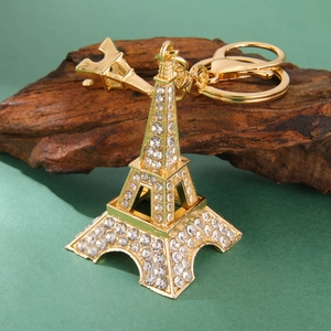 Detailed close-up of a luxury gold Eiffel Tower keychain with sparkling crystal rhinestones
