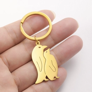 Polished gold penguin keychain set in 304 stainless steel with minimalist animal design