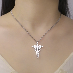 Close-up of a silver Caduceus pendant necklace on a model showing medical symbol details