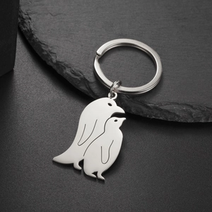 Polished stainless steel penguin pendant keychain with reflective mirror finish detail