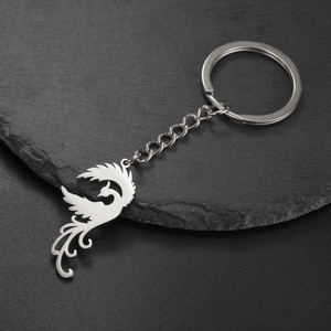 Detailed view of silver phoenix phoenix key chain in 304 stainless steel on dark rock