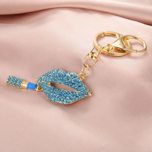 Vue détaillée d'un porte-clés doré avec des lèvres en strass bleus et un rouge à lèvres