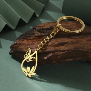 Detailed close-up of golden stainless steel keychain with hollow butterfly pendant