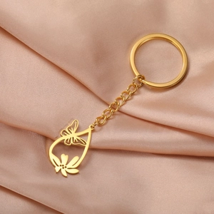 Detailed shot of golden stainless steel hollow butterfly and flower keychain pendant