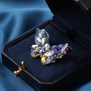 Elegant crystal butterfly brooch with pearls in a blue jewelry gift box