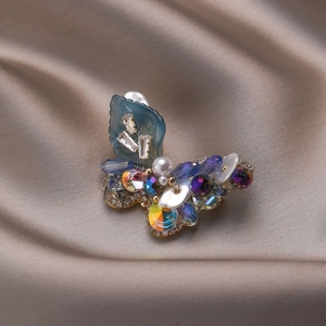 Exquisite crystal butterfly brooch with blue leaves and pearls on champagne satin