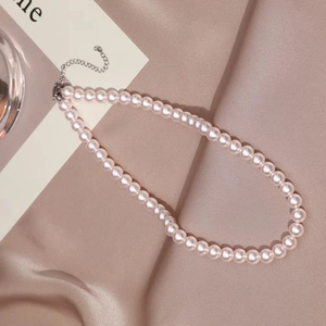 Elegant pink pearl necklace with silver adjustable extension chain on pink silk