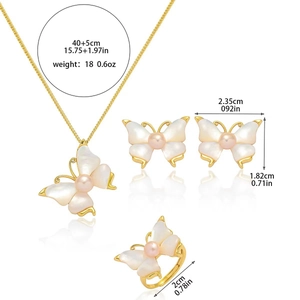 Detailed view of butterfly jewelry set including necklace earrings and ring with pearls