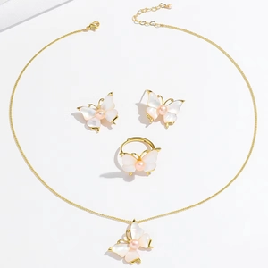 Elegant gold butterfly jewelry set with shell wings and pearls including necklace and ring